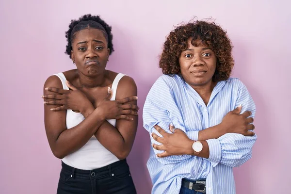 Two African Women Standing Pink Background Shaking Freezing Winter Cold — Stok fotoğraf