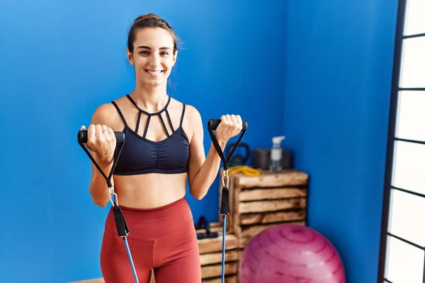 Young Hispanic Woman Smiling Confident Training Using Elastic Band Sport —  Fotos de Stock