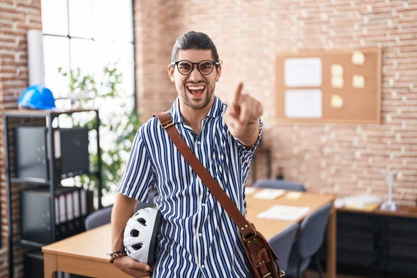 Hispanic Man Long Hair Working Office Holding Bike Helmet Pointing — Stockfoto