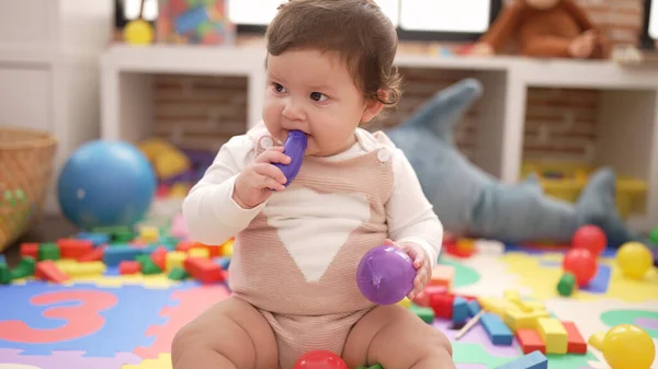Adorable Toddler Bitting Plastic Food Toy Sitting Floor Kindergarten — Stockfoto