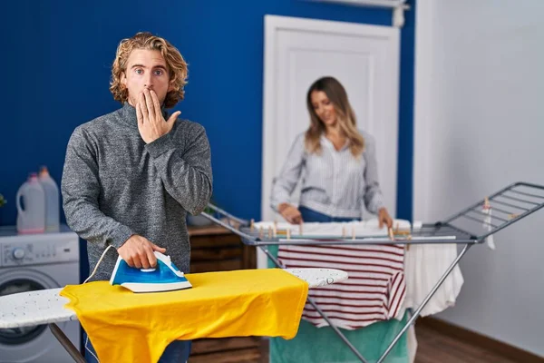 Couple Ironing Clothes Laundry Room Covering Mouth Hand Shocked Afraid — Stok fotoğraf