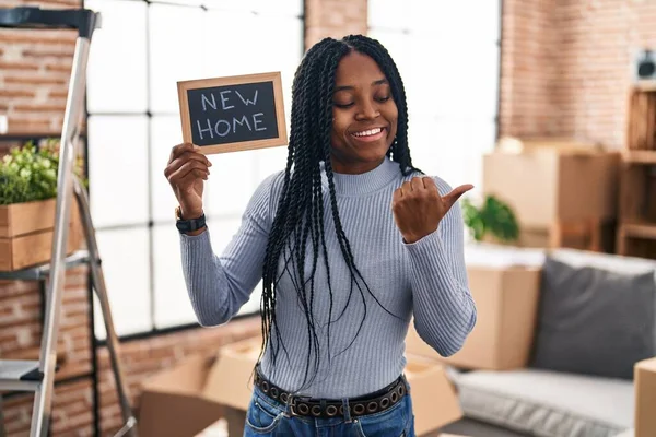 African American Woman Holding Blackboard New Home Text Pointing Thumb — Foto de Stock