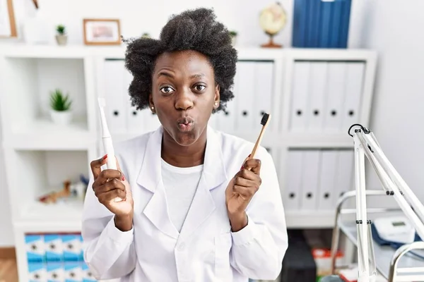 African Dentist Woman Holding Electric Toothbrush Normal Toothbrush Puffing Cheeks — Photo