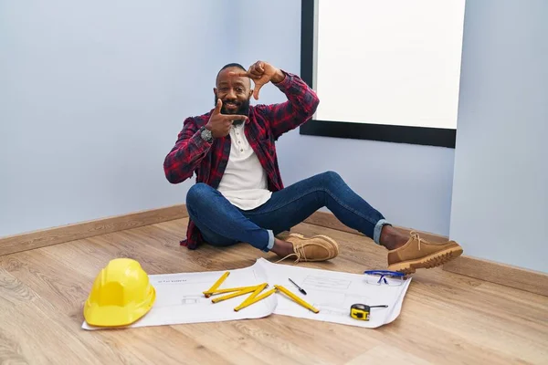 African American Man Sitting Floor New Home Looking Blueprints Smiling — Stok fotoğraf