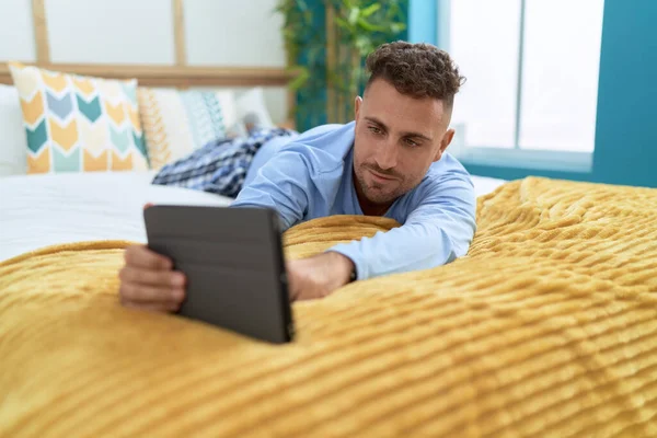 Young Hispanic Man Using Touchpad Lying Bed Bedroom — Zdjęcie stockowe
