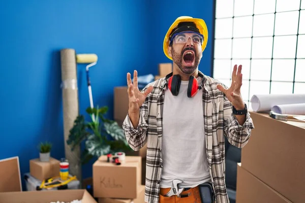 Young Hispanic Man Beard Working Home Renovation Crazy Mad Shouting — Zdjęcie stockowe