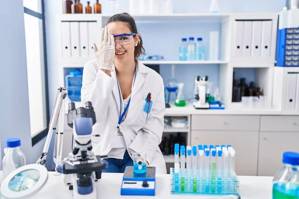 Young Hispanic Woman Working Scientist Laboratory Covering One Eye Hand — Stock fotografie