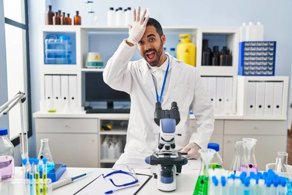 Young Hispanic Man Beard Working Scientist Laboratory Surprised Hand Head — Stock Photo, Image