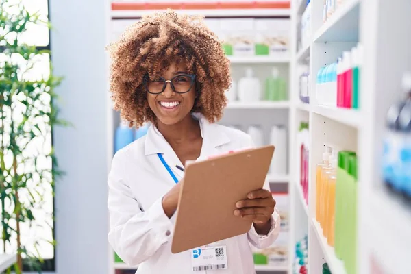 African American Woman Pharmacist Smiling Confident Writing Document Pharmacy — Photo