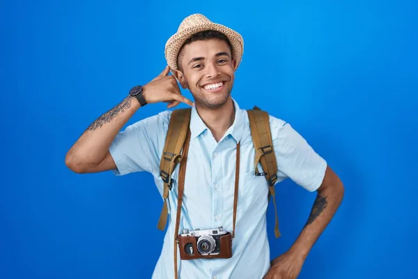 Brazilian Young Man Holding Vintage Camera Smiling Doing Phone Gesture —  Fotos de Stock