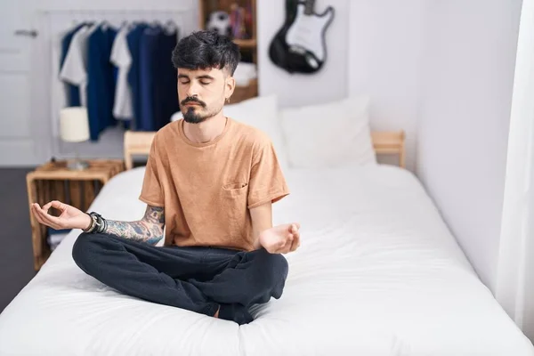 Young Hispanic Man Doing Yoga Exercise Sitting Bed Bedroom — Stock fotografie