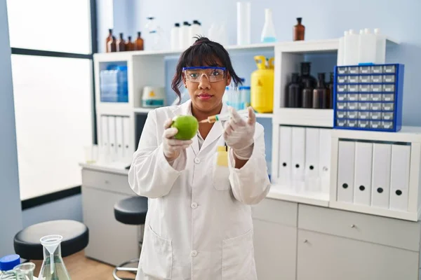 Hispanic Woman Working Scientist Laboratory Apple Skeptic Nervous Frowning Upset — Foto de Stock