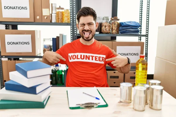 Young Man Beard Wearing Volunteer Shirt Donations Stand Sticking Tongue — Zdjęcie stockowe