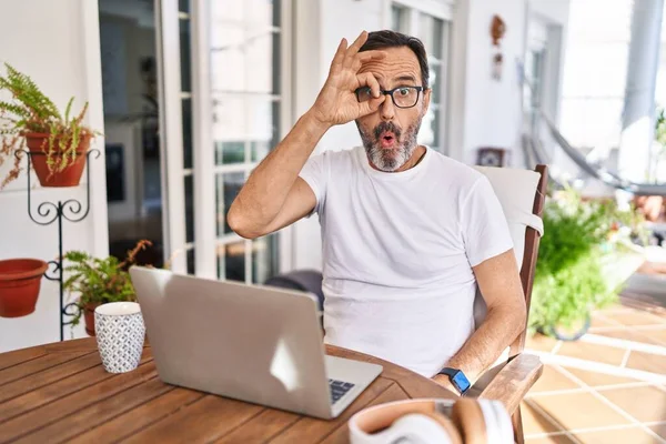 Middle Age Man Using Computer Laptop Home Doing Gesture Shocked — Stock Photo, Image