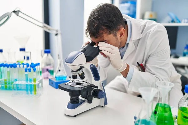 Young Hispanic Man Scientist Using Microscope Laboratory — Stock Photo, Image