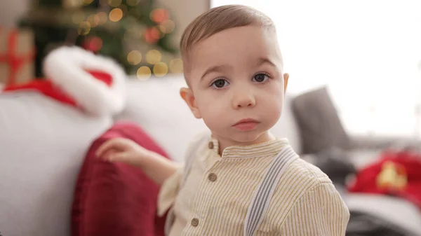 Adorable Toddler Standing Christmas Tree Serious Expression Home — Stock Photo, Image