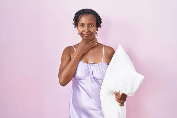 African Woman Dreadlocks Wearing Pajama Hugging Pillow Touching Painful Neck — 图库照片