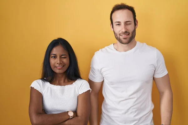 Interracial Couple Standing Yellow Background Winking Looking Camera Sexy Expression — 图库照片