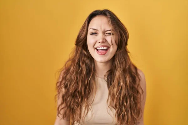 Young Hispanic Woman Standing Yellow Background Winking Looking Camera Sexy — Stockfoto