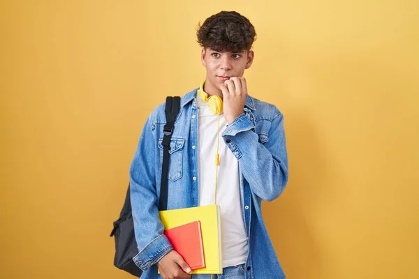 Hispanic Teenager Wearing Student Backpack Holding Books Looking Stressed Nervous — Stockfoto