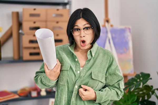 Young Asian Woman Holding Paper Art Studio Scared Amazed Open — ストック写真