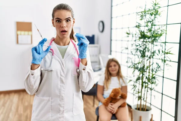 Young Doctor Woman Putting Vaccine Little Girl Shock Face Looking — Stockfoto