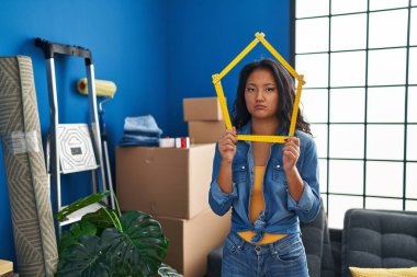 Young asian woman moving to a new home depressed and worry for distress, crying angry and afraid. sad expression. 
