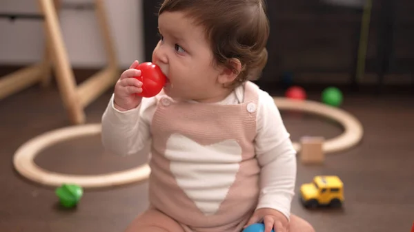 Adorable Toddler Sucking Plastic Ball Sitting Floor Kindergarten — Stockfoto