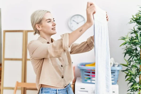 Young Caucasian Woman Smiling Confident Holding Clothes Laundry Room — Stockfoto