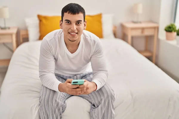 Young Man Using Smartphone Sitting Bed Bedroom — Stock Fotó