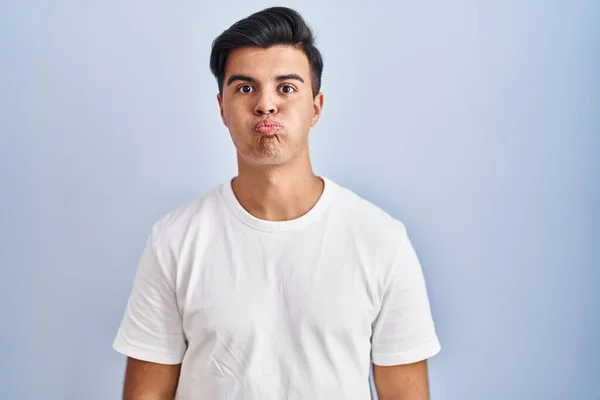 Hispanic Man Standing Blue Background Puffing Cheeks Funny Face Mouth —  Fotos de Stock