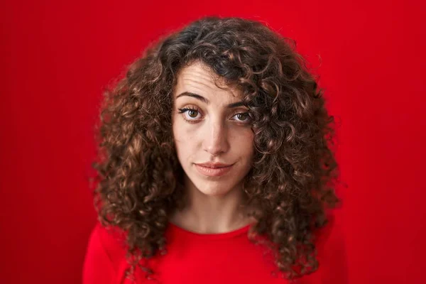 Hispanic Woman Curly Hair Standing Red Background Skeptic Nervous Frowning —  Fotos de Stock