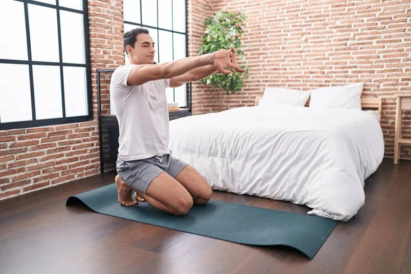Young Hispanic Man Stretching Arms Sitting Floor Bedroom — ストック写真