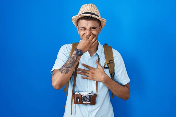 Brazilian Young Man Holding Vintage Camera Smelling Something Stinky Disgusting —  Fotos de Stock