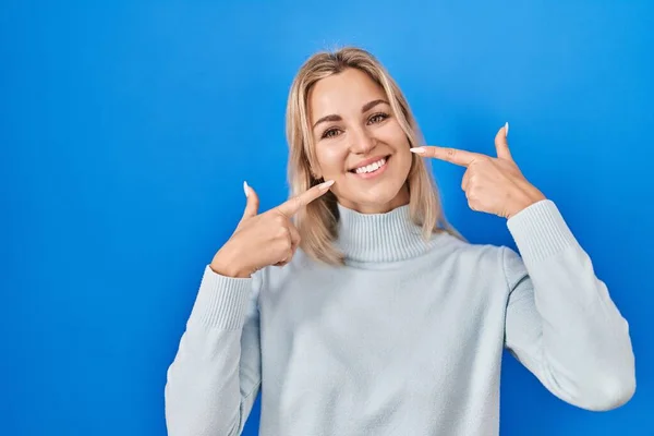 Young Caucasian Woman Standing Blue Background Smiling Cheerful Showing Pointing — ストック写真