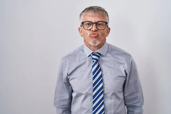 Hispanic Business Man Grey Hair Wearing Glasses Looking Camera Blowing — Stockfoto