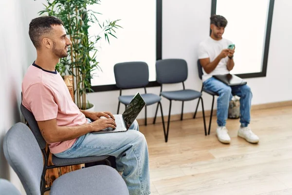 Two Hispanic Men Using Laptop Smartphone Sitting Chair Waiting Room — Stock Photo, Image
