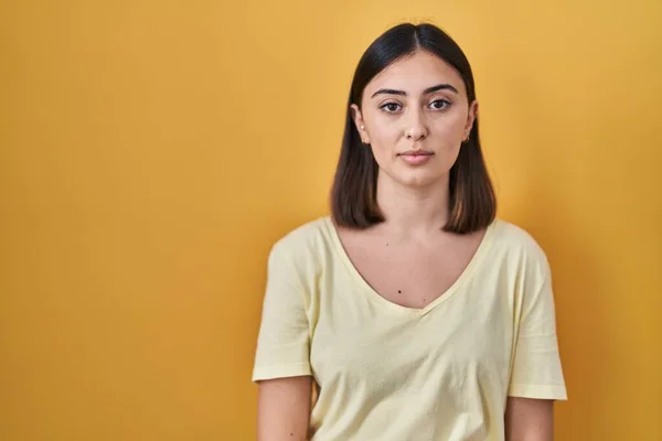 Hispanic Girl Wearing Casual Shirt Yellow Background Relaxed Serious Expression — Zdjęcie stockowe