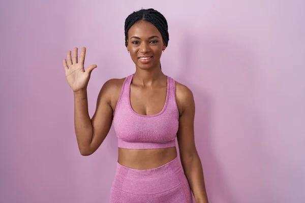 African American Woman Braids Wearing Sportswear Pink Background Showing Pointing — Zdjęcie stockowe