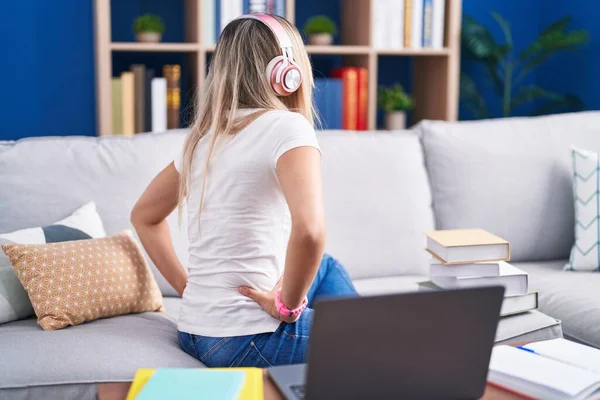 Young Blonde Woman Studying Using Computer Laptop Home Standing Backwards — Stockfoto