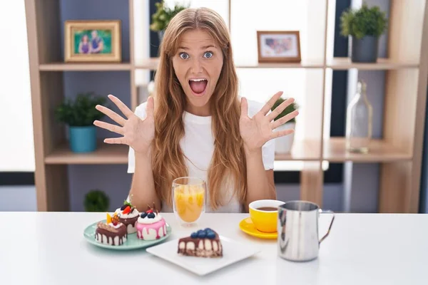 Young Caucasian Woman Eating Pastries Breakfast Celebrating Crazy Amazed Success — Stok fotoğraf