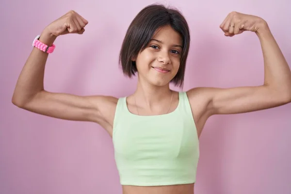 Young Girl Standing Pink Background Showing Arms Muscles Smiling Proud — Stockfoto