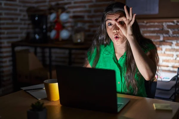 Young Teenager Girl Working Office Night Doing Gesture Shocked Surprised — kuvapankkivalokuva