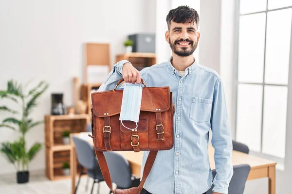 Young Hispanic Man Beard Working Office Holding Suitcase Safety Mask — Stockfoto