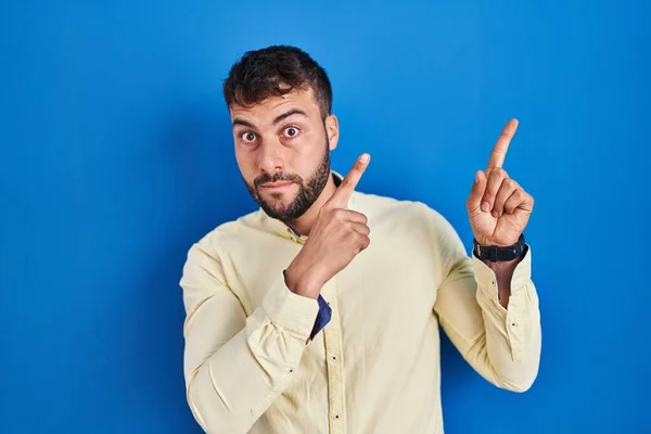 Handsome Hispanic Man Standing Blue Background Pointing Aside Worried Nervous — Stockfoto