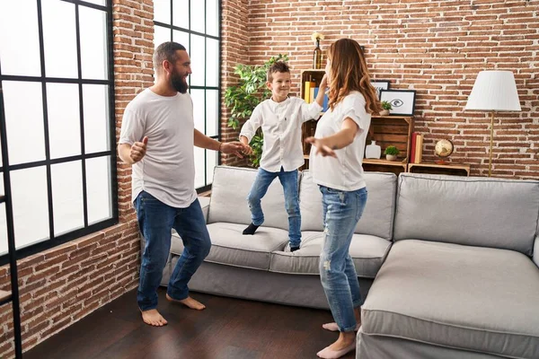 Family smiling confident dancing at home