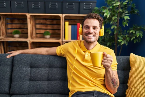 Young Hispanic Man Listening Music Drinking Coffee Home — Fotografia de Stock