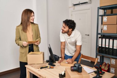 Man and woman business workers smiling confident working at office