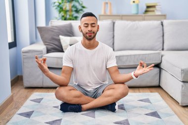 African american man training yoga at home