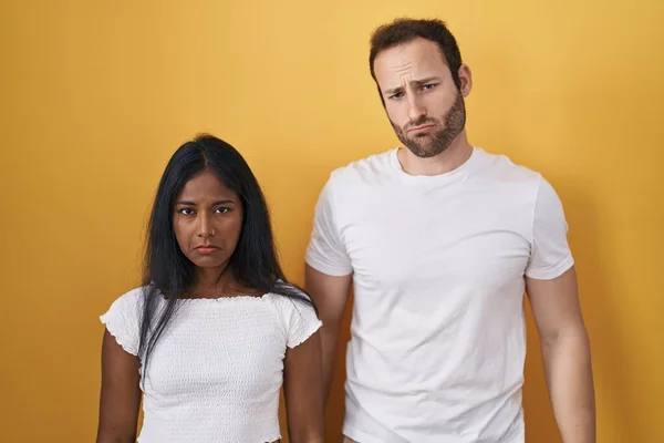 Interracial Couple Standing Yellow Background Depressed Worry Distress Crying Angry — Foto Stock